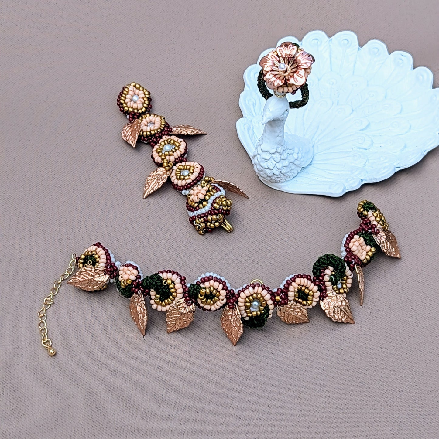 Expertly designed for comfort, this Indian hand bracelet (haath phool) blends traditional bridal elegance with modern style, exclusively from sustainable UK brand Mayaani Jewellery. Adorned with colourful beads and a striking rose gold flower, it can be worn as a bracelet or adjustable ring, showcasing India’s heritage. Blossoming in floral motifs, gold plated leaves and gold plated accents this piece is your go to accessory for everything from weddings, special occasions to everyday. 