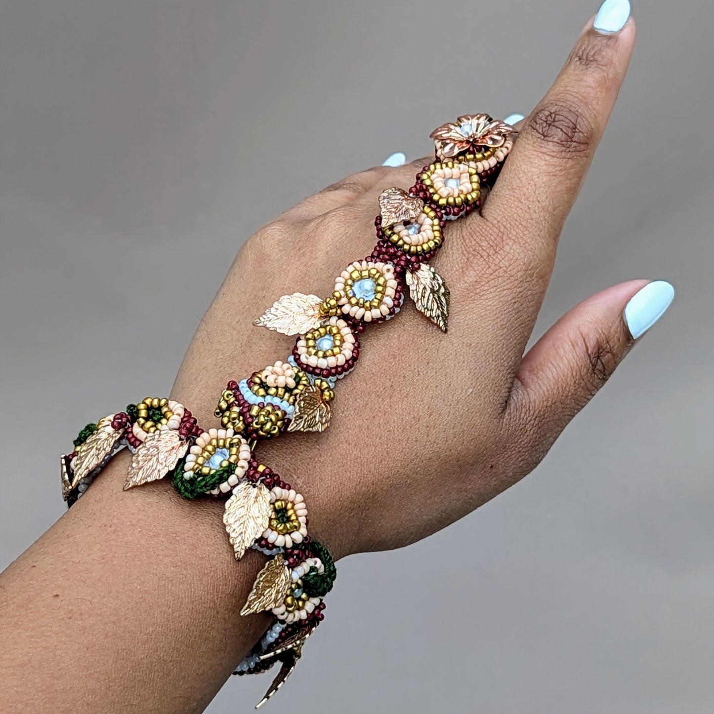 Crafted with care, this Indian hand bracelet (haath phool) combines the grace of traditional bridal jewellery with contemporary style, exclusive to sustainable UK brand Mayaani Jewellery. With vibrant red, green, and gold accents, it transforms easily from bracelet to adjustable ring, highlighting India’s heritage for all of your wedding, occasion and everyday style wishes.