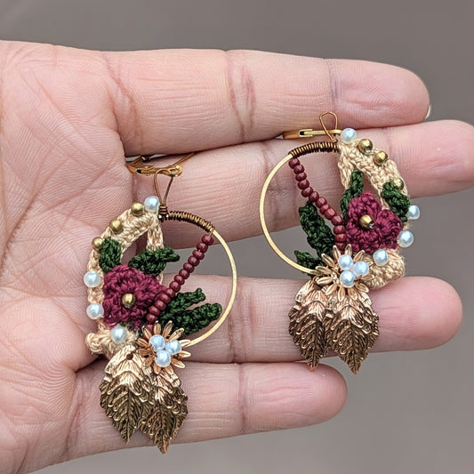 Elegant Indian earrings in traditional red, green, and gold, designed by UK artisan Megha of Mayaani Jewellery UK. These lightweight 14K gold plated hoops blend together with masterful hand crochet, hand wire wrapping and hand bead embroidery craftsmanship with sustainability perfect for any occasion.