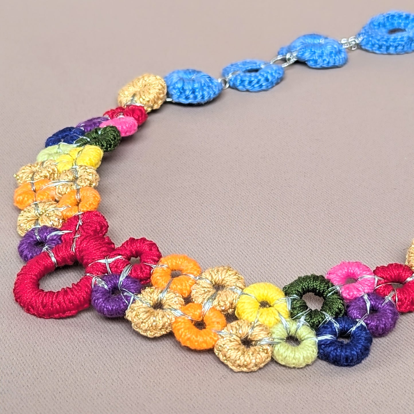 Artisan Handmade Rainbow Necklace by Sustainable UK Brand Mayaani Jewellery featuring exceptionally handcrafted crochet and wire wrapped circles, a clasp free finish and interchangeable chains for Bohemian chic style full of versatility and comfort.