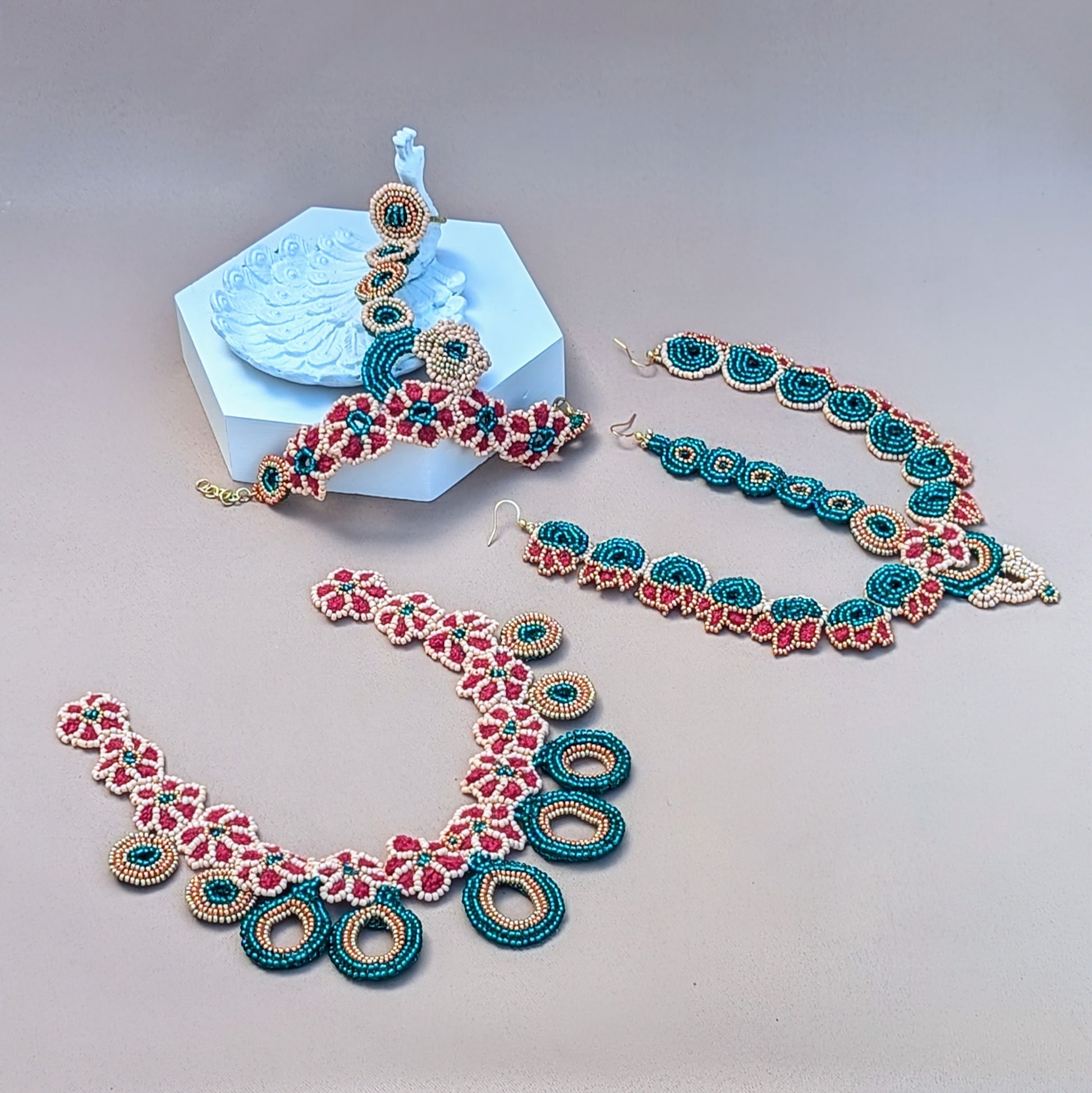 A beautifully handcrafted Indian-inspired jewellery collection by sustainable UK Indian wedding and occasion brand Mayaani Jewellery. Inspired by a cherry blossom lehenga seen by in-house designer Megha, this collection boasts intricate hand crochet, beadwork and wirework in red, emerald green and peach tones with rose gold and gold tones. The floral motifs and circular bead pendants blend traditional Indian bridal colours with a contemporary design making this a striking and elegant choice for any event.