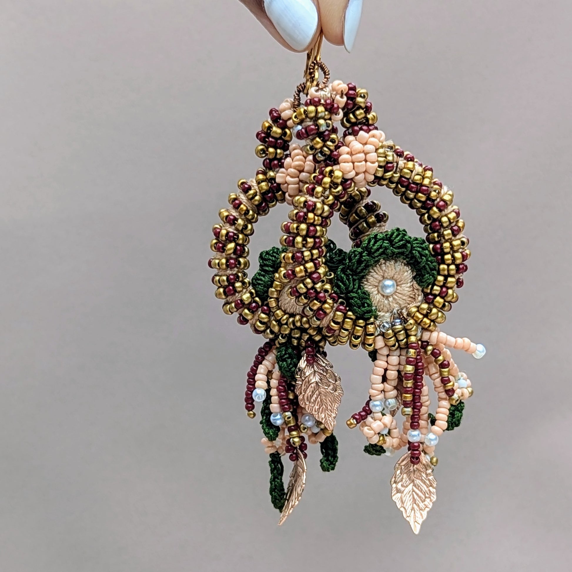 Mayaani Jewellery presents a unique artisan pair of Indian bridal earrings sustainably handcrafted with meticulous craftsmanship using high quality materials and featuring a blend of red, green and gold in keeping with traditional Indian bridal colours. 