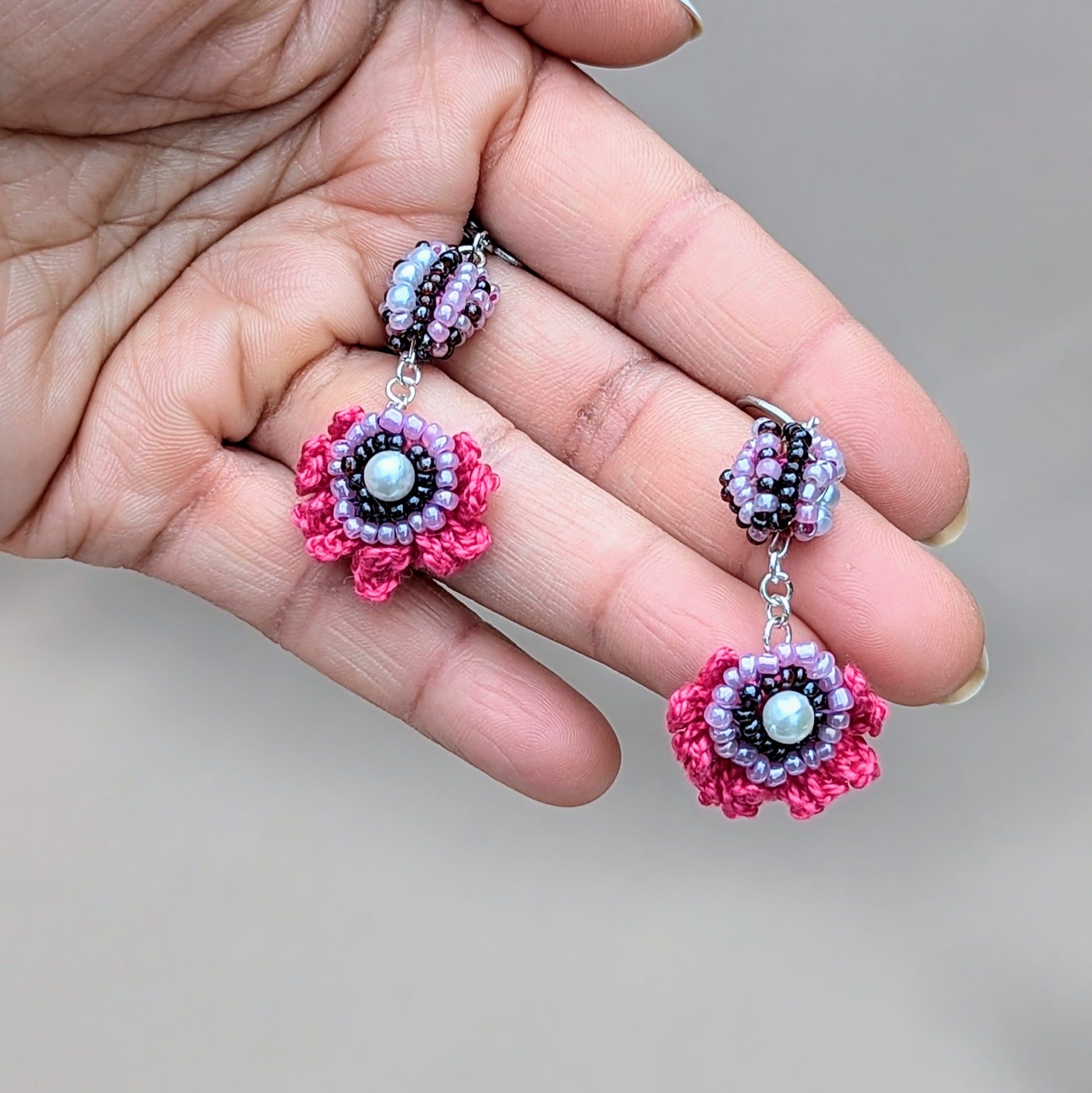 Make a statement with these playful, handcrafted earrings, exclusively from Mayaani Jewellery, a sustainable UK brand by designer Megha. With her signature scrap beads, these earrings blend hand crochet, exquisite beadwork, and wire wrapping in vivid pinks, purples, and lilac, accented by silver stainless steel clasp hooks. They’re a fantastic choice for a vibrant touch to any outfit, perfect for both occasions and everyday wear!