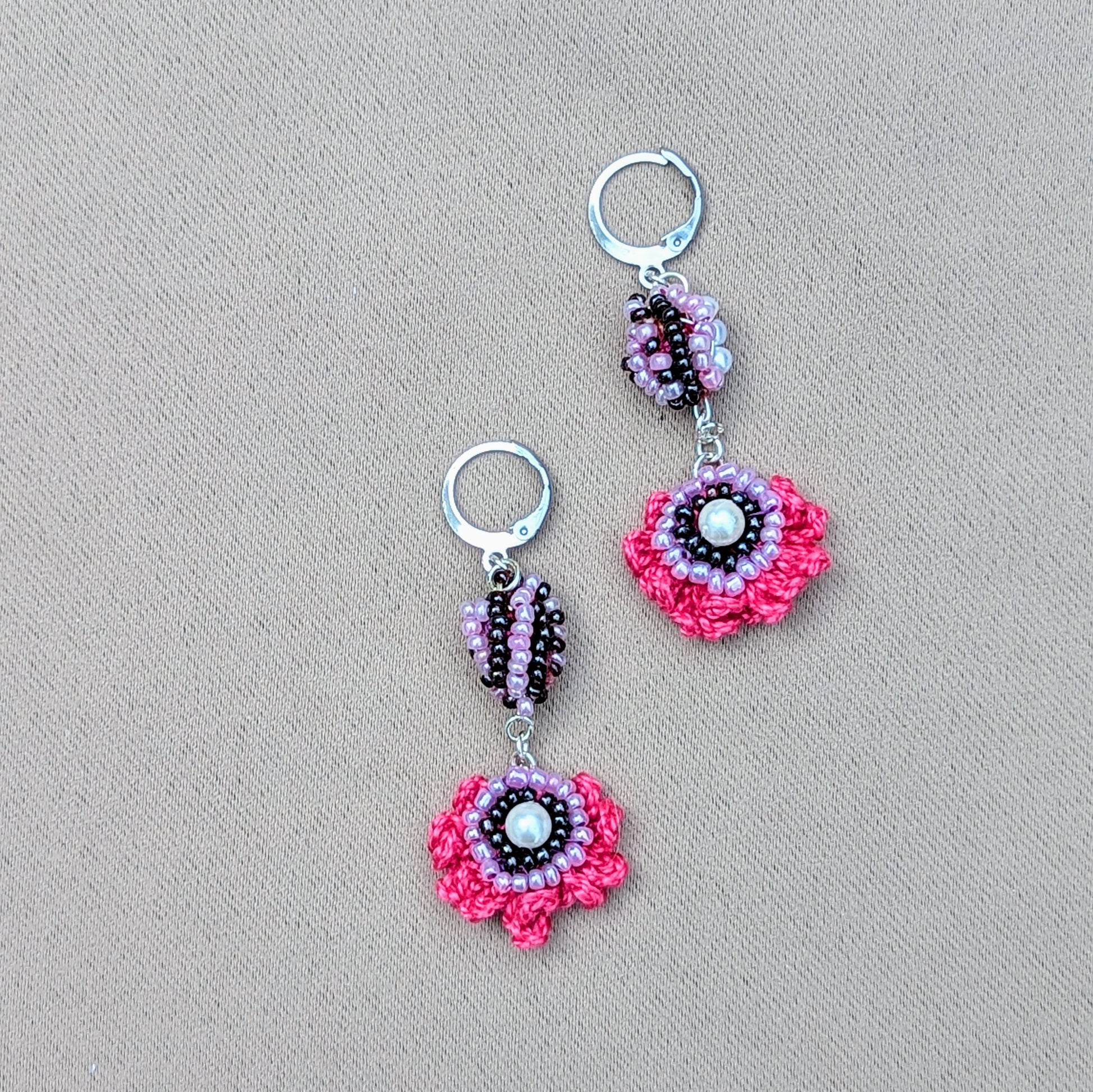 These eye-catching, colourful earrings are a unique creation by in-house designer Megha for Mayaani Jewellery, a sustainable UK brand. Featuring her signature concept of scrap beads, they combine hand crochet, beautiful beadwork, and wire wrapping in radiant shades of pink, purple, and lilac, finished with durable silver stainless steel clasp hooks. A perfect way to add a burst of colour to any look, whether for a special event or your daily attire!