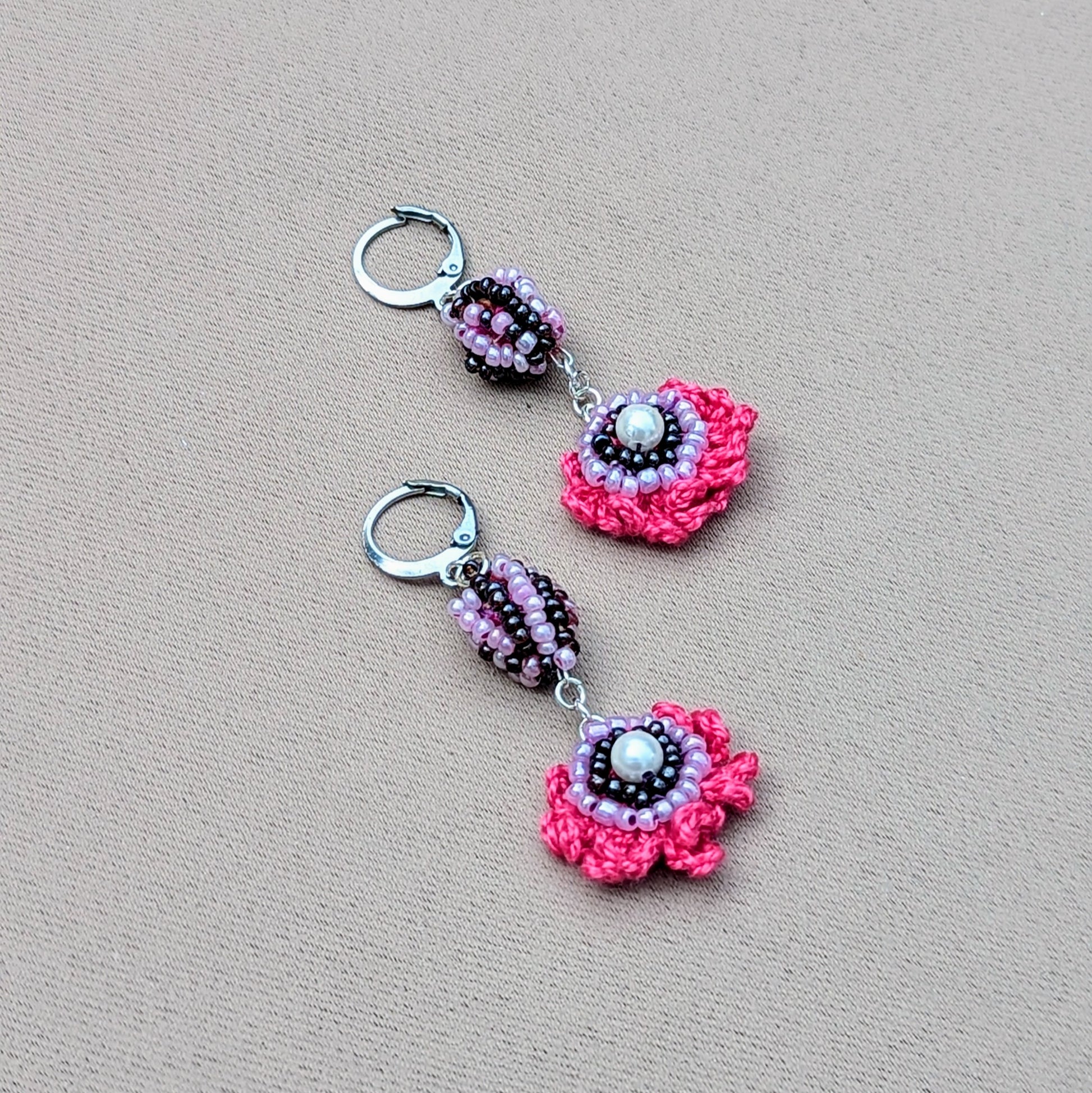 Discover these striking, colourful handcrafted earrings, an exclusive design from sustainable UK brand Mayaani Jewellery by in-house designer Megha. Showcasing her unique concept of scrap beads, these earrings feature hand crochet, detailed beadwork, and wire wrapping in vibrant pinks, purples, and lilac, all complemented by silver stainless steel clasp hooks. They’re the perfect accessory to brighten up any outfit, whether for special occasions or everyday wear!