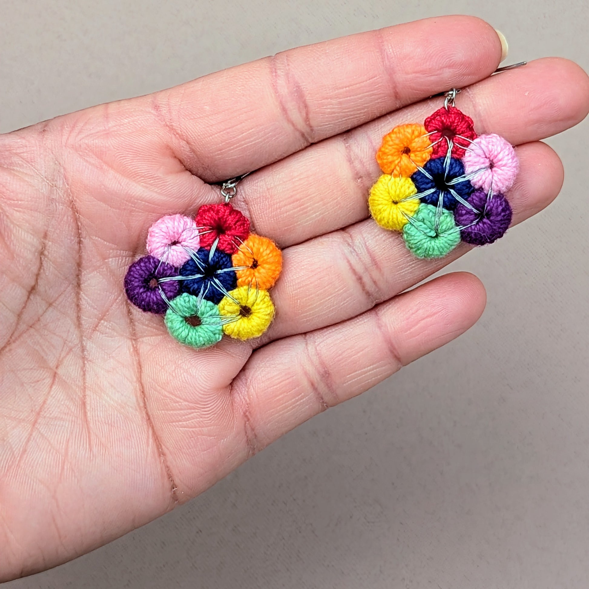 Embrace the charm of a colorful circular rainbow with this unique pair of earrings from the sustainable Indian brand Mayaani Jewellery UK. A perfect accent to brighten your mood and elevate your everyday style! Made with hand-crocheted circles and wrapped in silver-plated copper wire, these eye-catching earrings are finished with sturdy stainless steel hooks.