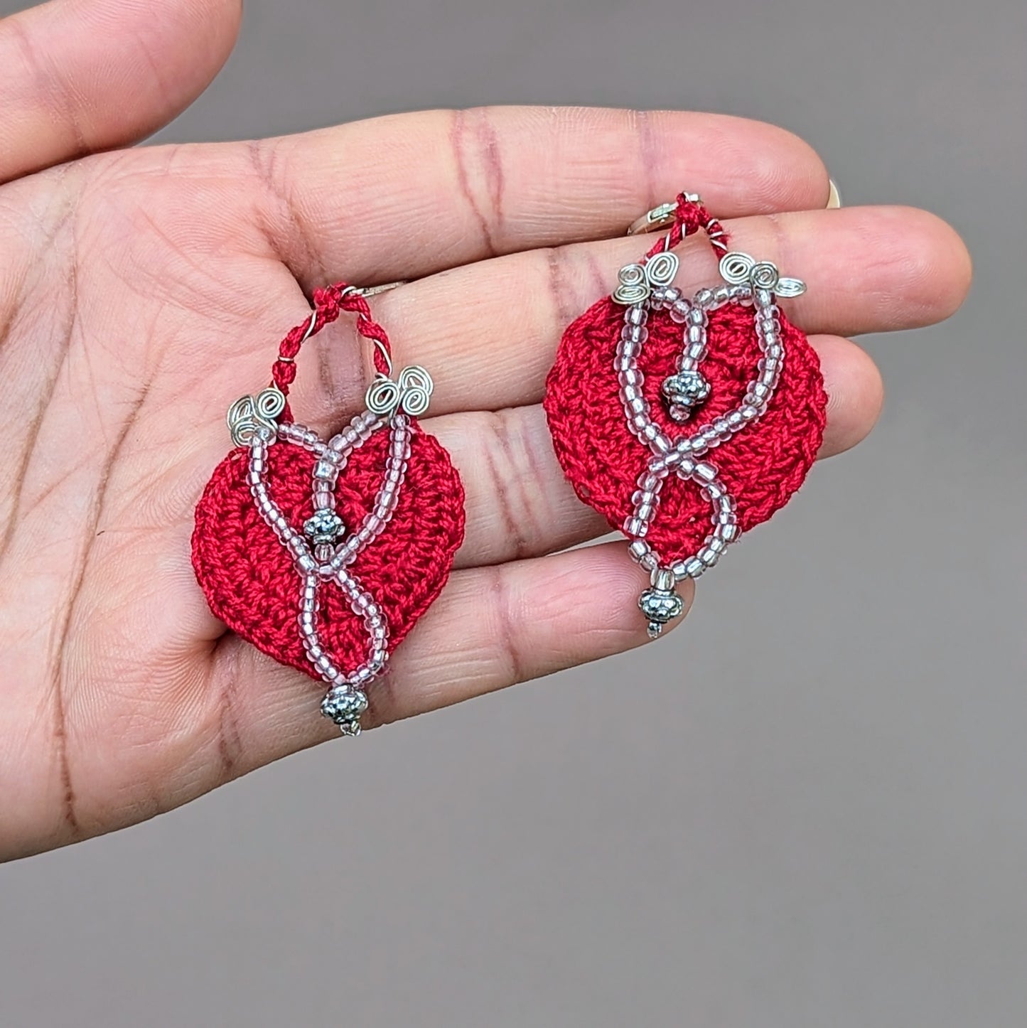 Handcrafted with care, these exclusive Mayaani Jewellery UK earrings are made with vibrant red crochet, accented by silver lined beads, high quality upcycled beads and silver-plated copper wire all finished off with 925 stamped sterling silver lever back hooks. These earrings offer both beauty and sustainability, embodying Mayaani Jewellery's dedication to ethical fashion.