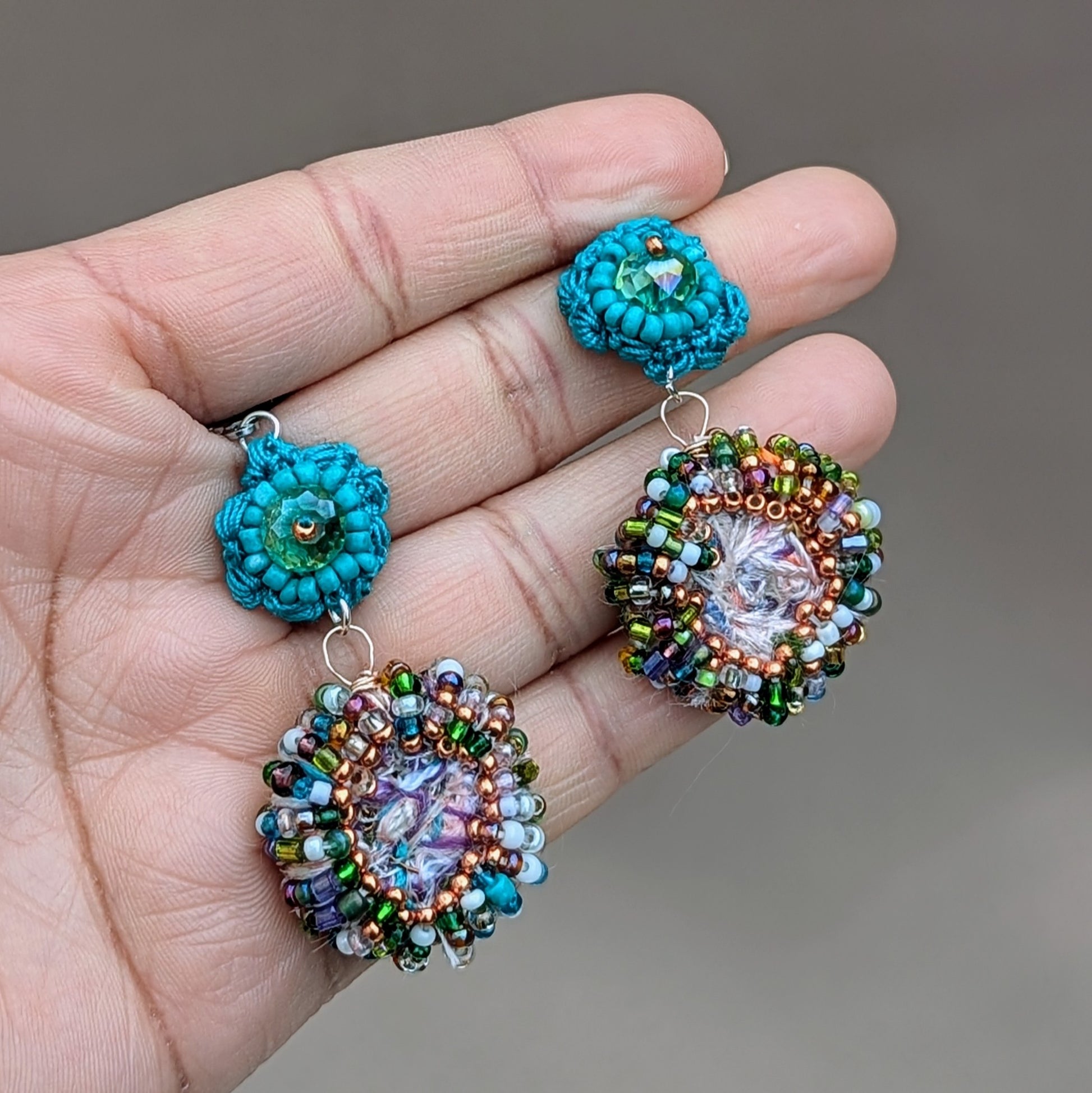 Unique scrap bead earrings by Mayaani Jewellery UK, inspired by crystal-clear ocean waters and Indian artistry. Handcrafted from leftover materials, they feature vibrant new and upcycled seed beads and a turquoise flower motif—ideal for weddings or daily outfits.