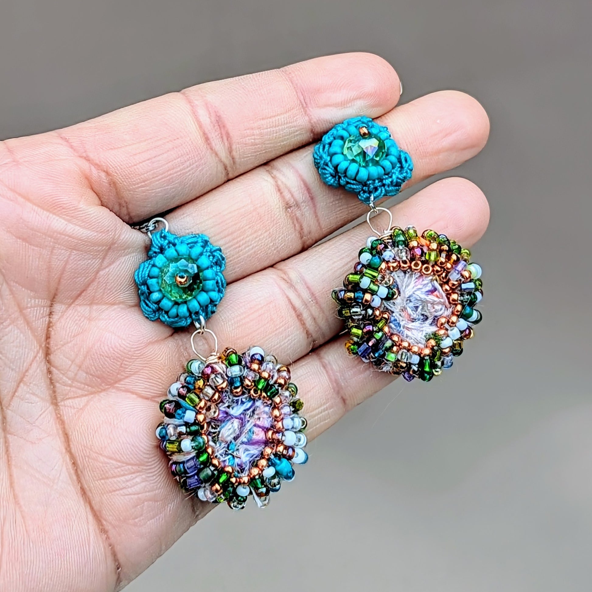 Eye-catching sustainable scrap bead earrings from Mayaani Jewellery UK, inspired by ocean waters and Indian aesthetics. Handcrafted with leftover materials, they showcase vibrant upcycled seed beads and a turquoise flower motif, ideal for weddings and daily wear.